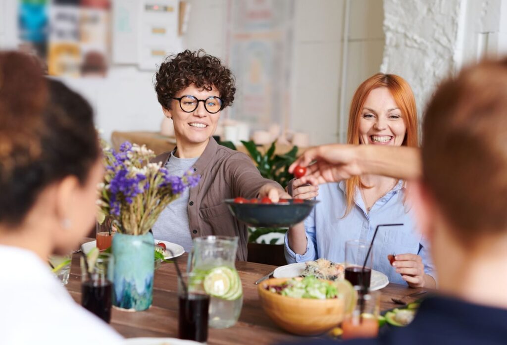A happy group of friends and family enjoying a meal together indoors. Perfect for themes of togetherness and joy.